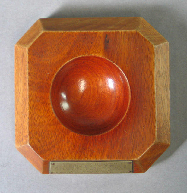 Cricket ball stand with plaque, presented to H de V Moll by Rhodesian
